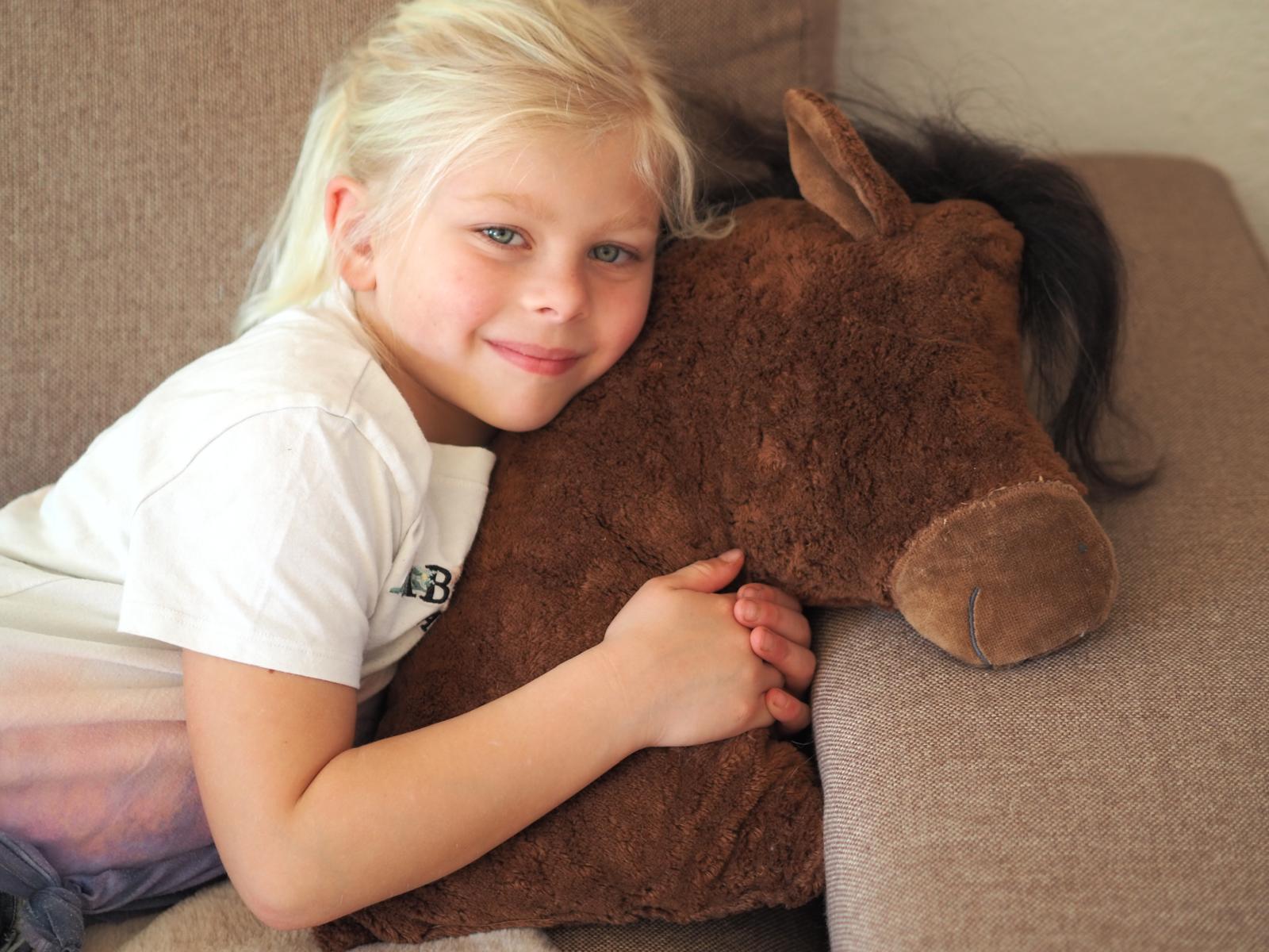 Mother and child with wool toy in sunlit room