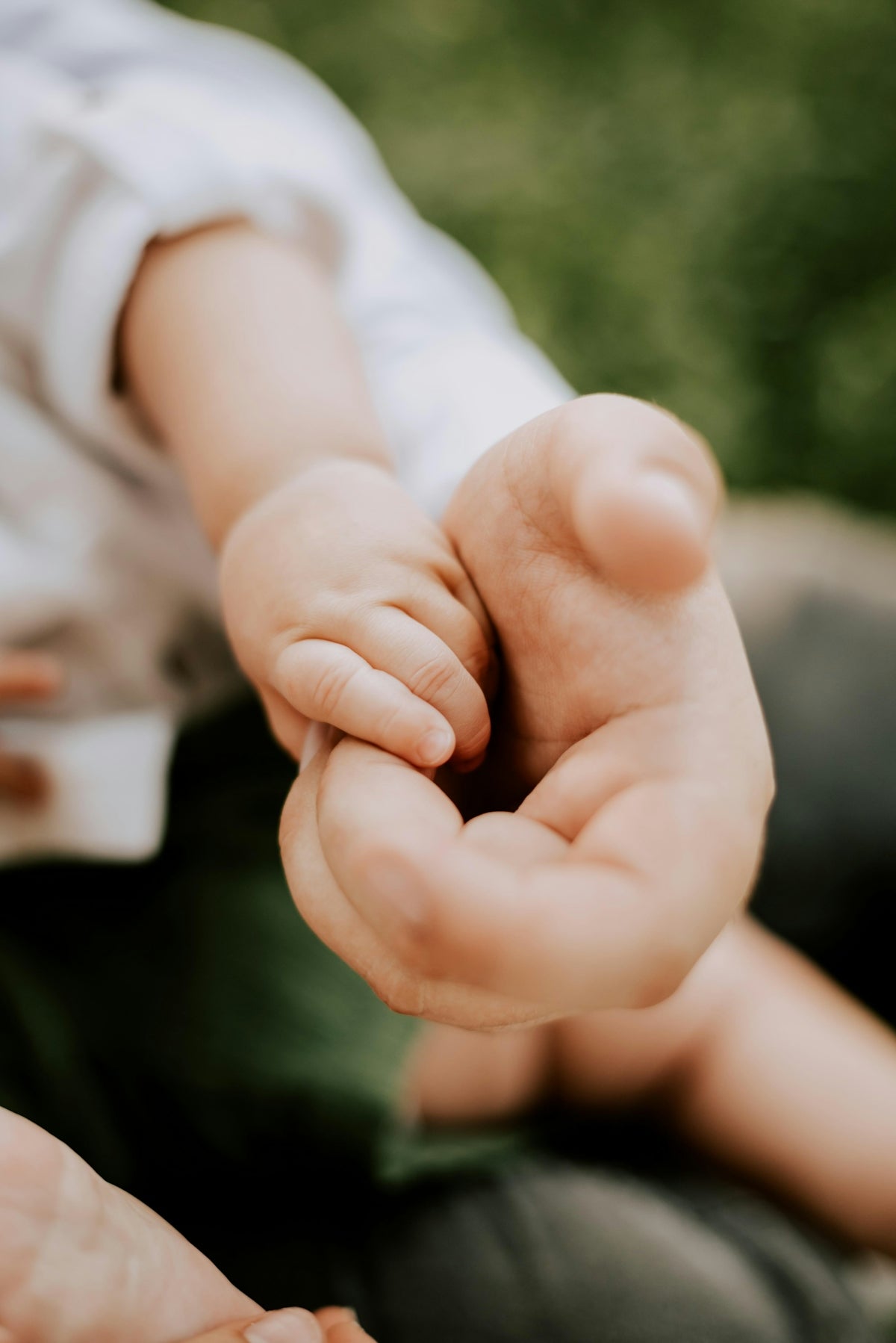person holding babys hand