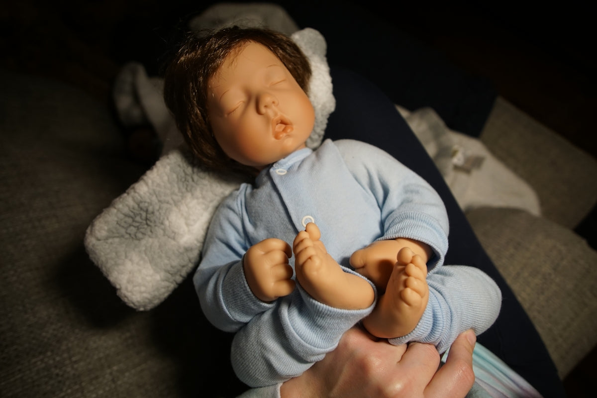 a baby doll being held by a person